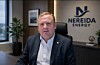 Geir Bjørkeli sitter på et kontor foran Nereida Energy-logoen.